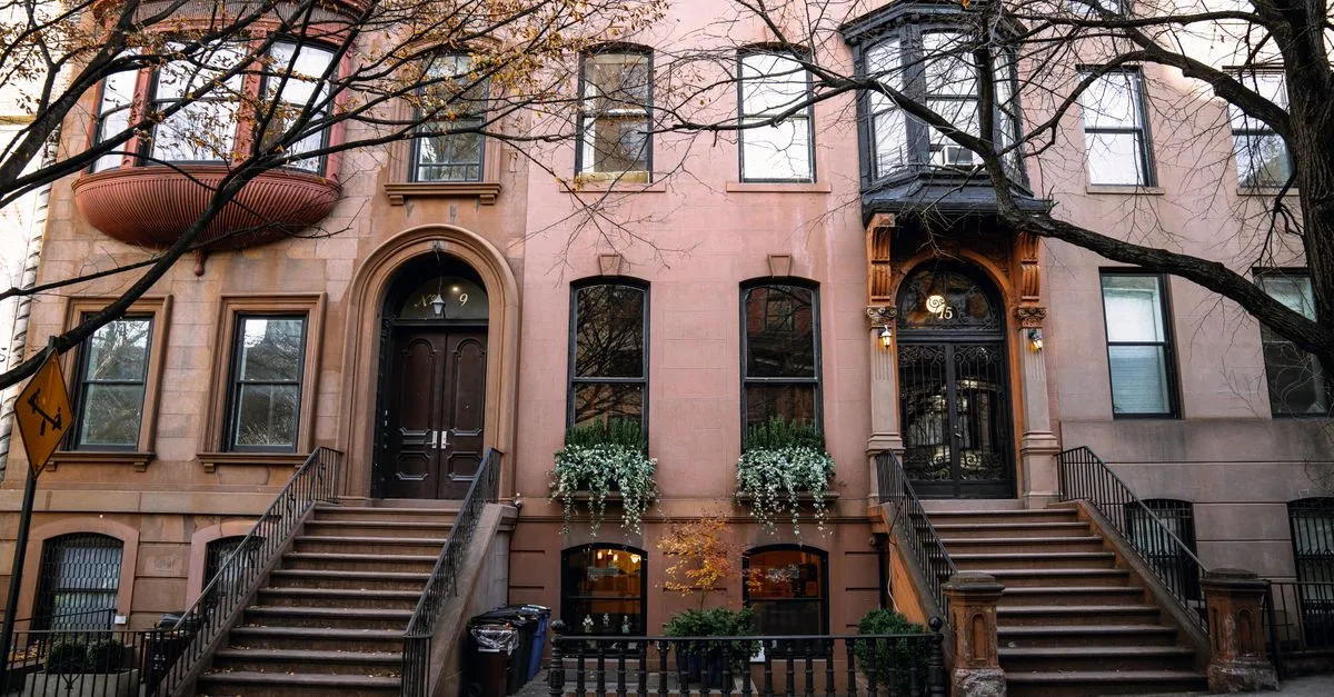 Brownstone buildings in Brooklyn, New York, showcasing autumn charm.